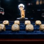 Klay Thompson net worth 2026 — NBA championship rings and wealth symbols representing 140 million dollar fortune